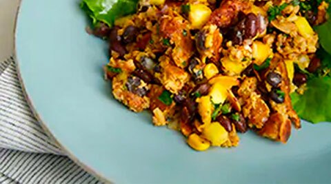 Morningstar Farms Veggie Churizo Crumbles mixed with eggs and beans on a plate.