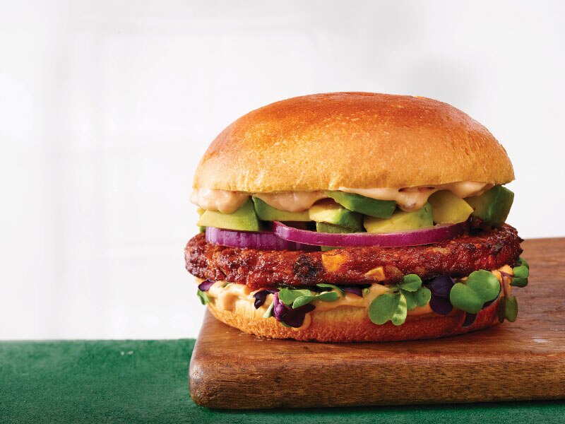 Burger with avocado, red onion and microgreens
